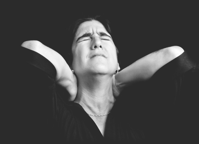 black-and-white-portrait-of-a-stressed-woman-suffering-from-neck-pain-640x0.jpg